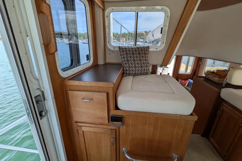 Slide: The Image of Interior of 2005 American Tug 41 with wooden cabinetry and cushioned seating. - 45