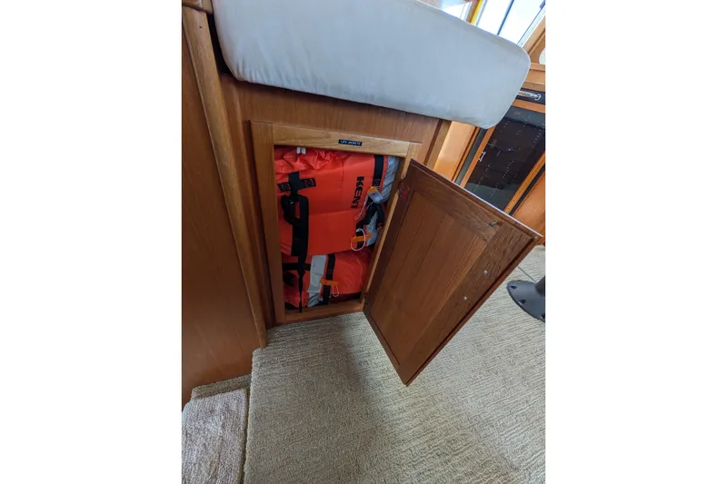 Slide: The Image of Storage compartment with life jackets on a 2005 American Tug 41 boat. - 48
