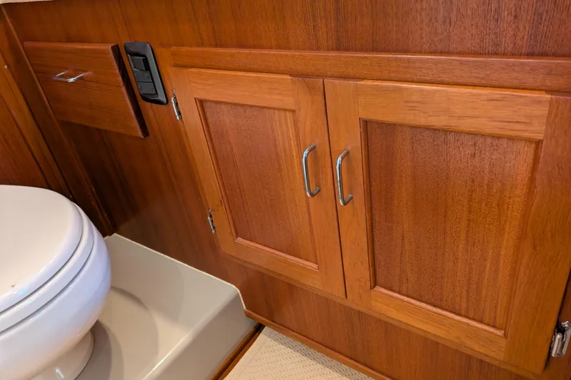 Slide: The Image of Wooden cabinetry and toilet in 2005 American Tug 41 boat interior. - 51