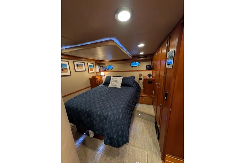 Slide: The Image of Cozy bedroom interior of 2005 American Tug 41 with wood accents and nautical decor. - 52
