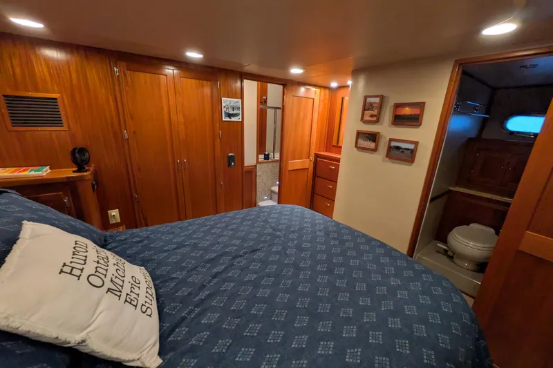 Slide: The Image of Luxurious cabin interior of 2005 American Tug 41 with wood finishes and cozy bedding. - 54