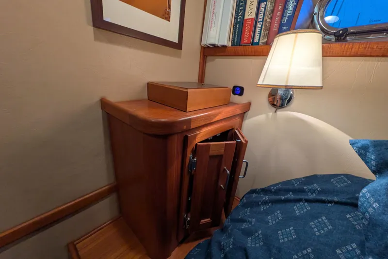 Slide: The Image of Cozy cabin interior of 2005 American Tug 41 with wooden cabinet and reading lamp. - 56