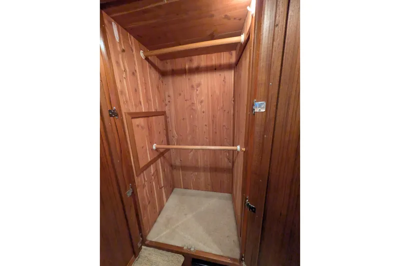 Slide: The Image of Wooden closet interior on a 2005 American Tug 41 boat. - 59