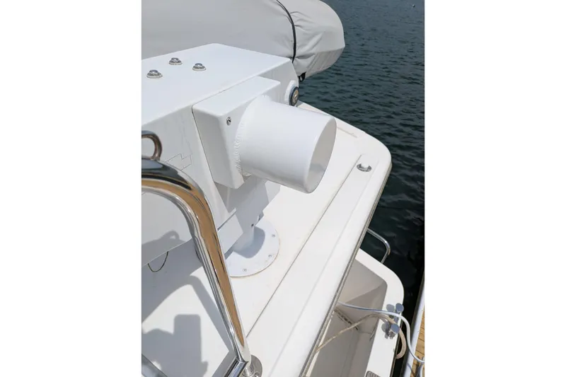 Slide: The Image of White deck detail of a 2005 American Tug 41 boat, overlooking water. - 6