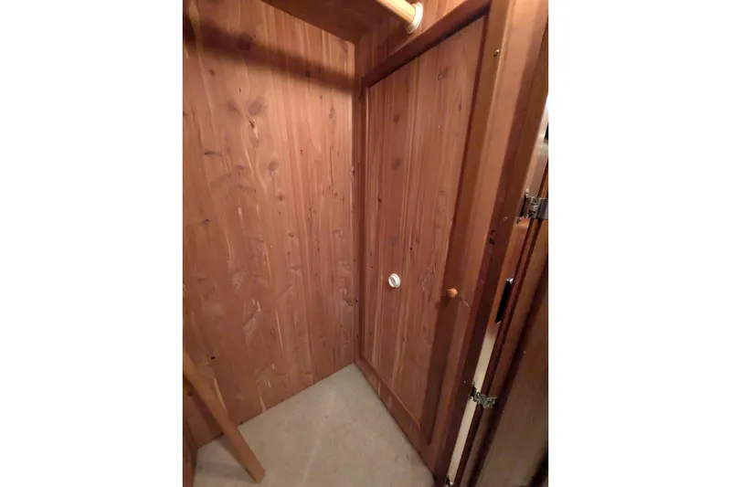 Slide: The Image of Wood-paneled interior of 2005 American Tug 41, featuring a closed door and cozy design. - 60