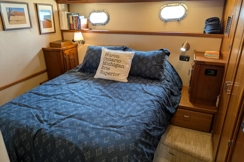 Slide: The Image of Cozy bedroom in 2005 American Tug 41 with nautical decor and wooden furnishings. - 63
