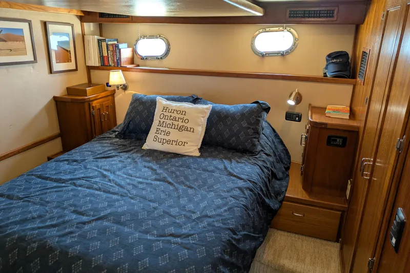 Slide: The Image of Cozy cabin interior of 2005 American Tug 41 with nautical decor and comfortable bedding. - 64