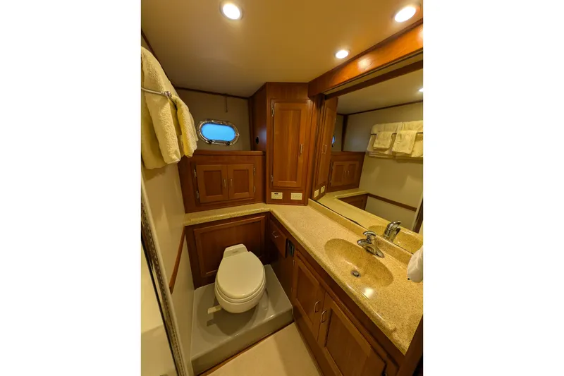 Slide: The Image of Luxurious bathroom in 2005 American Tug 41 yacht with wood cabinetry and modern fixtures. - 66