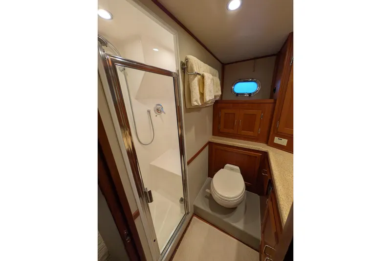Slide: The Image of Luxurious bathroom in 2005 American Tug 41 with shower, toilet, and wooden cabinetry. - 67