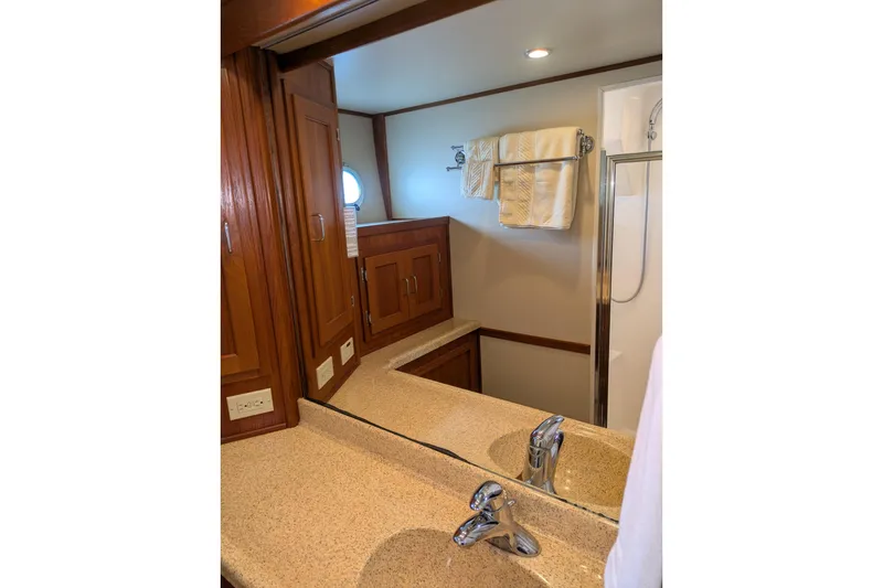 Slide: The Image of Bathroom interior of 2005 American Tug 41 with wooden cabinets and modern fixtures. - 69