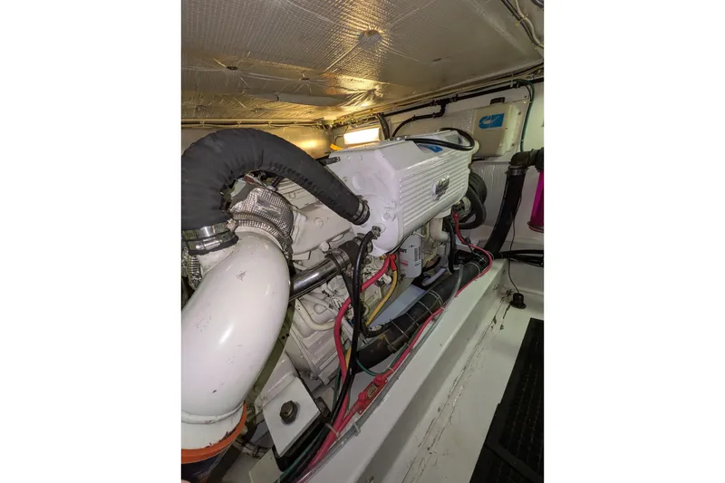 Slide: The Image of Engine room of a 2005 American Tug 41, showcasing mechanical components. - 73