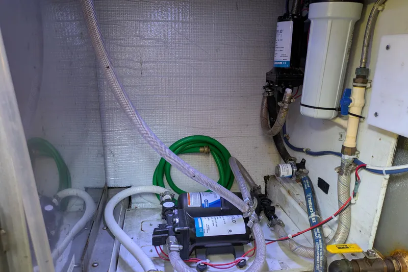 Slide: The Image of Engine room of a 2005 American Tug 41 with visible hoses and equipment. - 75