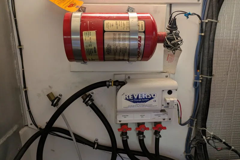 Slide: The Image of Engine room of 2005 American Tug 41 with fire extinguisher and Reverso oil change system. - 76