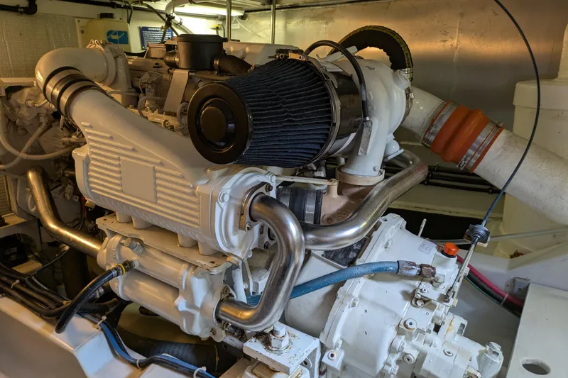Slide: The Image of Engine room of a 2005 American Tug 41, showcasing detailed mechanical components. - 77