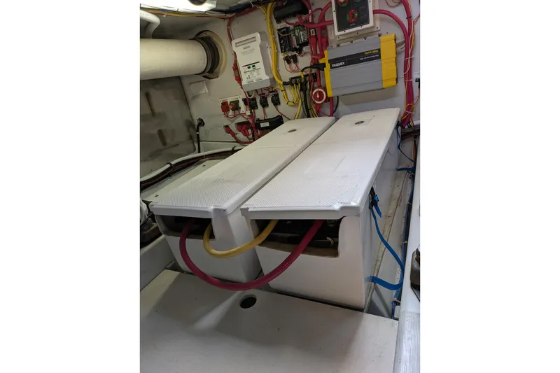 Slide: The Image of Engine room of a 2005 American Tug 41 with electrical components and wiring. - 78