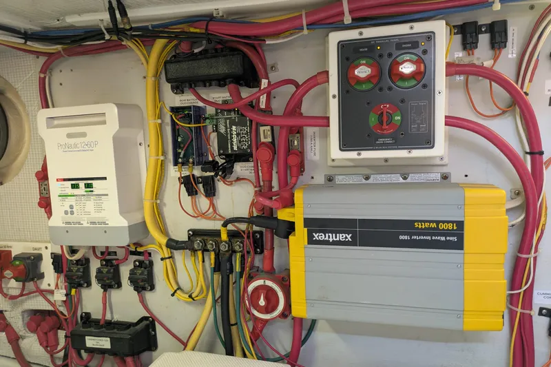 Slide: The Image of Electrical system setup in a 2005 American Tug 41, featuring ProNautic charger and Xantrex inverter. - 79