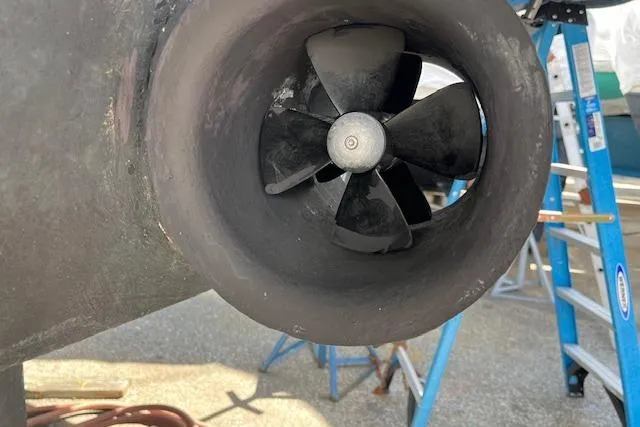 Slide: The Image of Close-up of a 2005 American Tug 41 propeller with a ladder in the background. - 8
