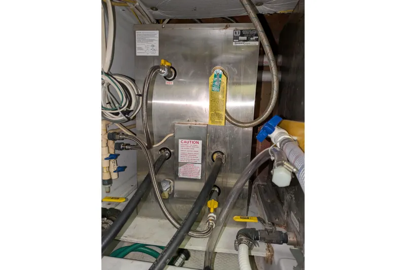 Slide: The Image of Engine room of a 2005 American Tug 41 with various pipes and equipment. - 81