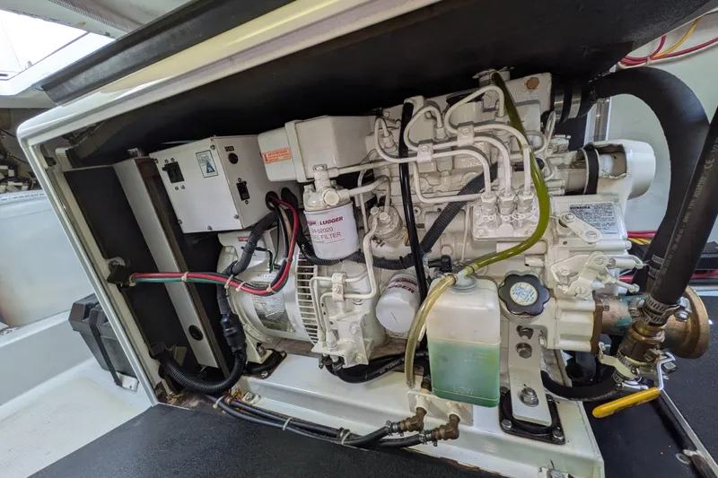 Slide: The Image of Engine compartment of a 2005 American Tug 41, showcasing detailed mechanical components. - 85