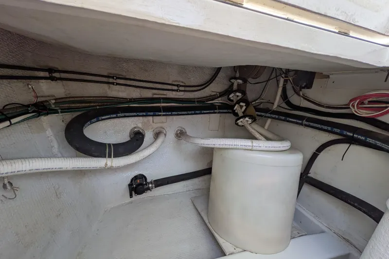 Slide: The Image of Engine room of 2005 American Tug 41 with hoses and wiring. - 88