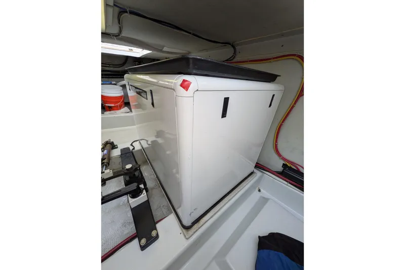 Slide: The Image of Engine compartment of a 2005 American Tug 41, featuring equipment and wiring. - 90