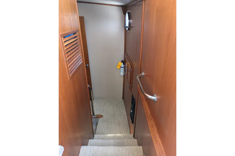 Slide: The Image of Interior stairs of 2005 American Tug 41 with wooden paneling and handrails. - 93