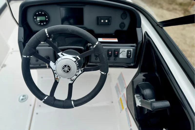 Slide: The Image of 2025 Yamaha Boats AR195 steering wheel and dashboard controls. - 12
