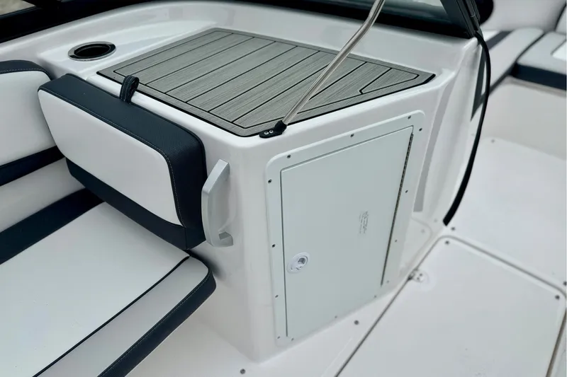 Slide: The Image of 2025 Yamaha Boats AR195 interior with sleek seating and storage compartment. - 14