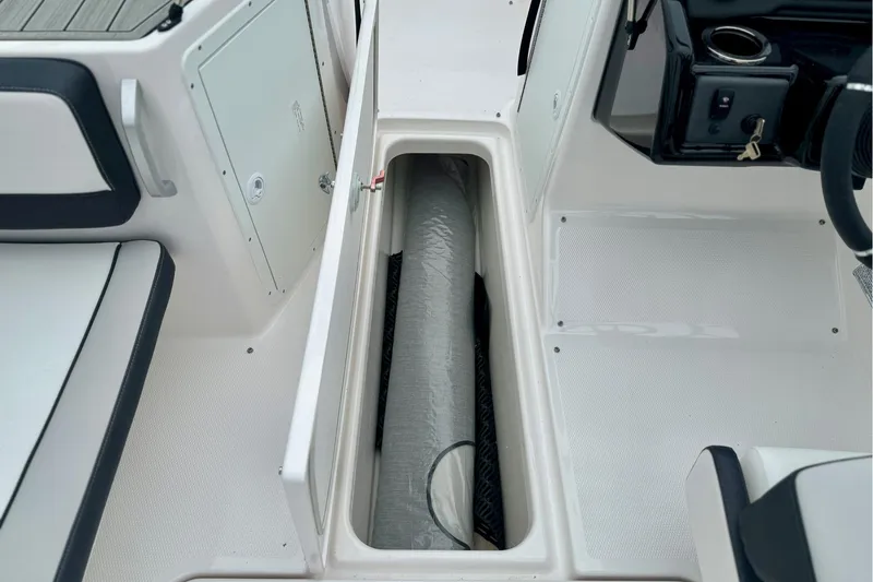 Slide: The Image of 2025 Yamaha Boats AR195 interior storage compartment with sleek design and modern features. - 15