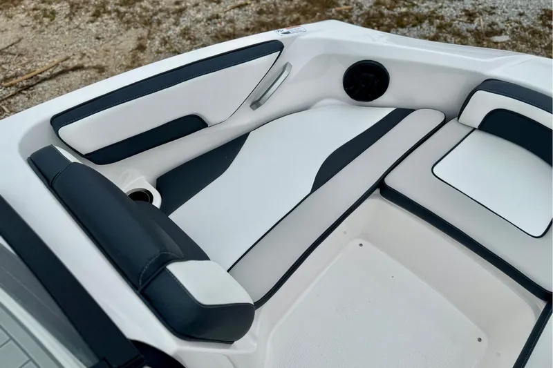 Slide: The Image of 2025 Yamaha Boats AR195 interior seating with sleek white and black design. - 17