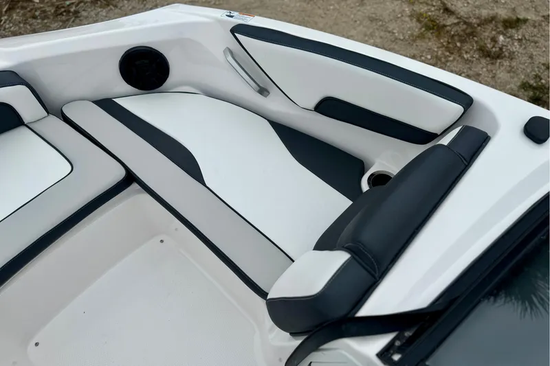 Slide: The Image of 2025 Yamaha Boats AR195 interior seating with sleek black and white design. - 18