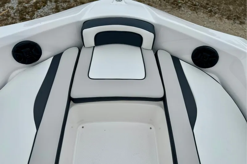 Slide: The Image of 2025 Yamaha Boats AR195 interior seating with sleek design and integrated speakers. - 19