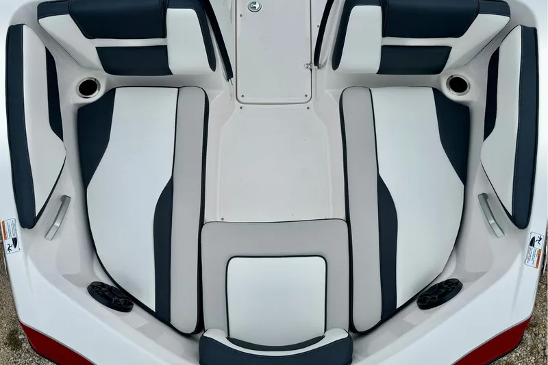 Slide: The Image of 2025 Yamaha Boats AR195 interior seating, featuring sleek white and dark upholstery design. - 23
