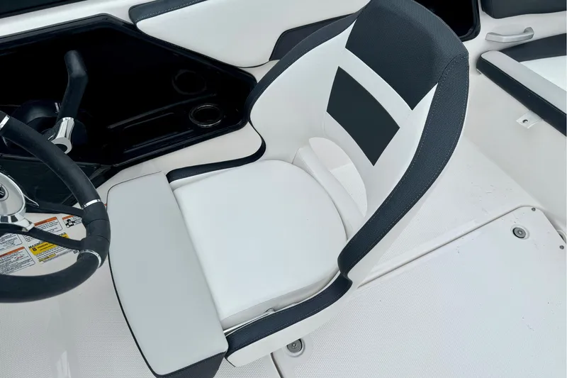 Slide: The Image of 2025 Yamaha Boats AR195 cockpit with sleek black and white seating and steering wheel. - 25