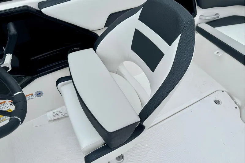 Slide: The Image of 2025 Yamaha Boats AR195 interior with sleek, modern seating and steering wheel design. - 26