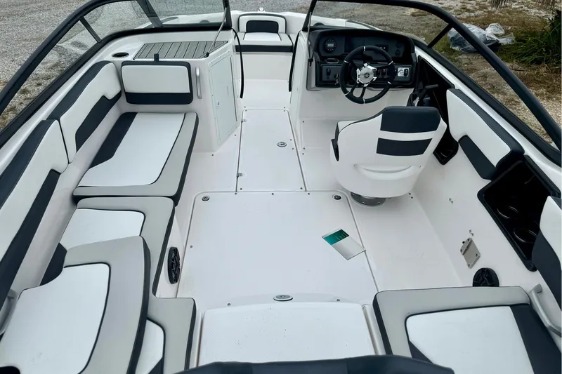 Slide: The Image of 2025 Yamaha Boats AR195 interior with sleek seating and modern dashboard design. - 6