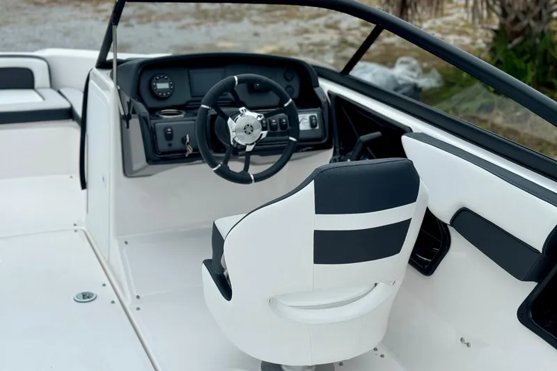 Slide: The Image of 2025 Yamaha Boats AR195 interior with steering wheel and captain's chair. - 7