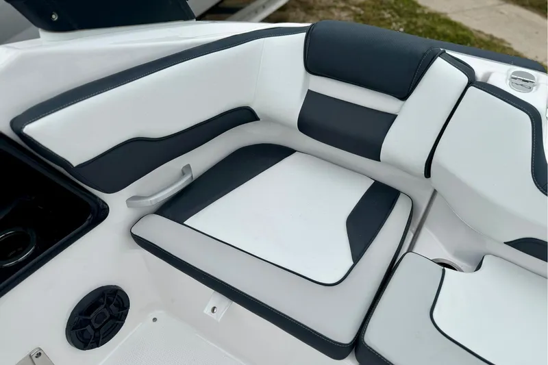 Slide: The Image of 2025 Yamaha Boats AR195 interior seating with sleek black and white upholstery design. - 9