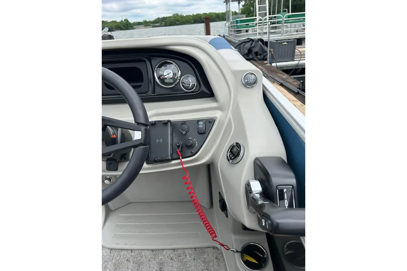 Slide: The Image of 2025 Southbay 224RSLE25 boat dashboard with steering wheel and control panel. - 11