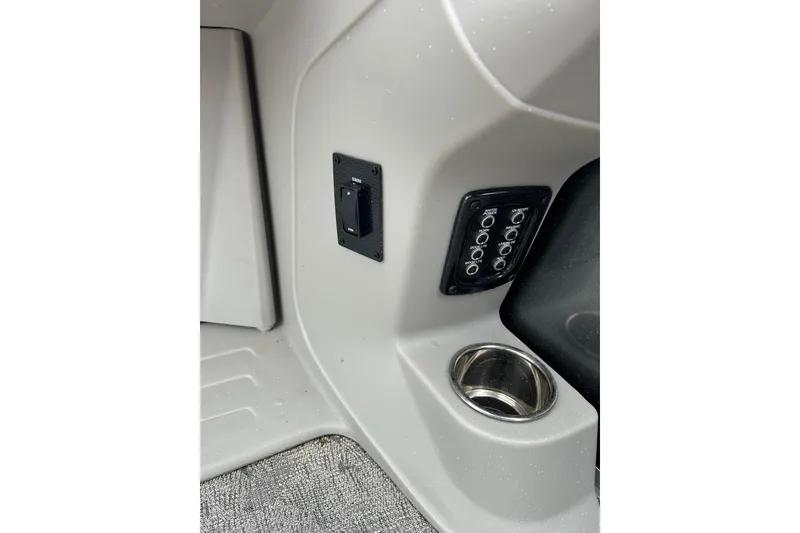 Slide: The Image of Interior controls of 2025 Southbay 224RSLE25 boat with cup holder and switch panel. - 15