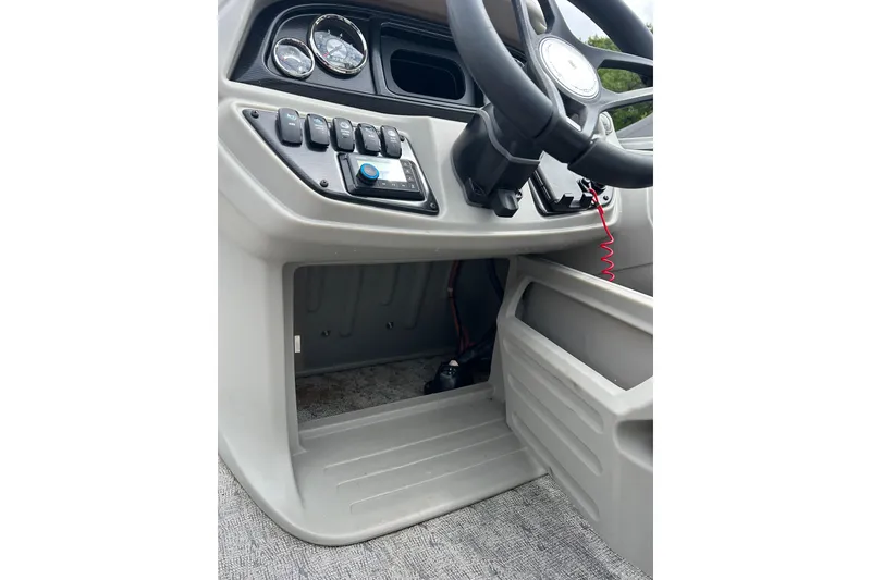 Slide: The Image of 2025 Southbay 224RSLE25 boat dashboard with steering wheel and control panel. - 19