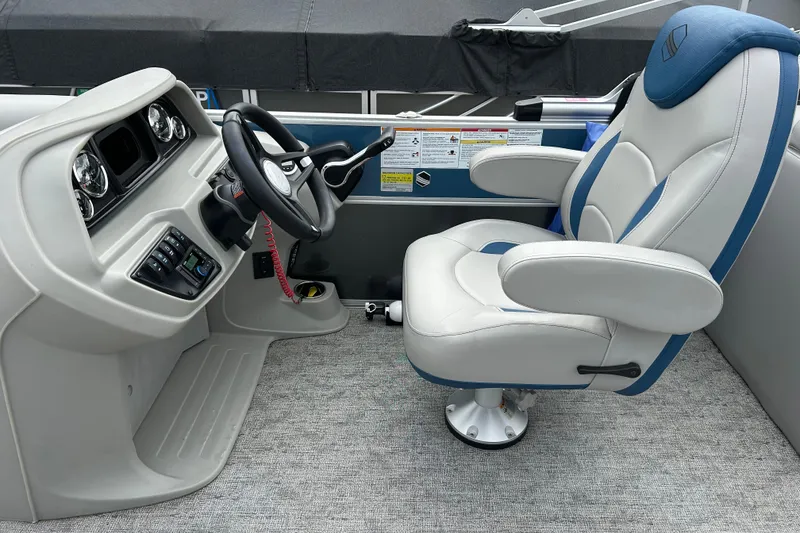 Slide: The Image of Captain's chair and helm of 2025 Southbay 224RSLE25 pontoon boat, featuring modern controls. - 6