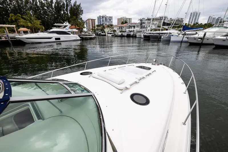 Slide: The Image of 2007 Sea Ray 340 Sundancer yacht docked in a marina with surrounding boats. - 10