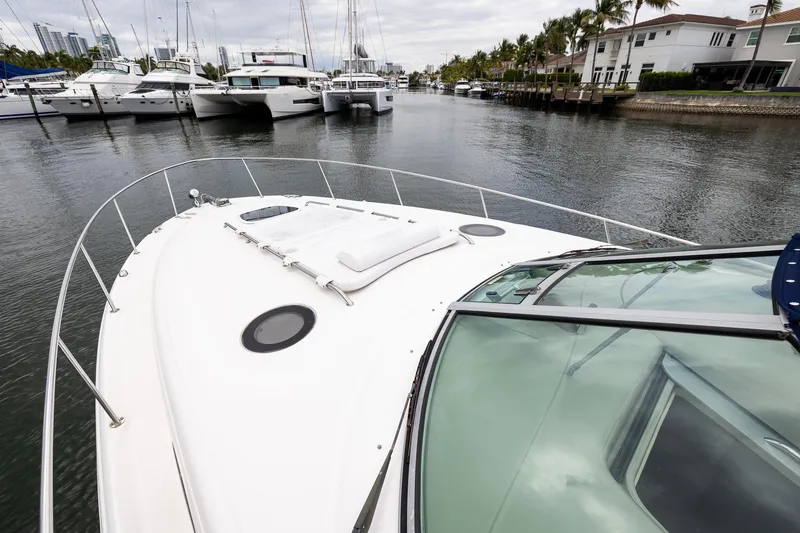 Slide: The Image of 2007 Sea Ray 340 Sundancer yacht docked in a marina, surrounded by other boats. - 11