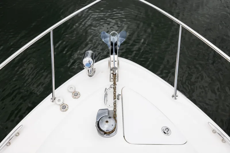 Slide: The Image of Bow of 2007 Sea Ray 340 Sundancer with anchor and railing over water. - 13