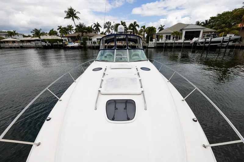 Slide: The Image of 2007 Sea Ray 340 Sundancer yacht docked in a scenic waterfront setting. - 14