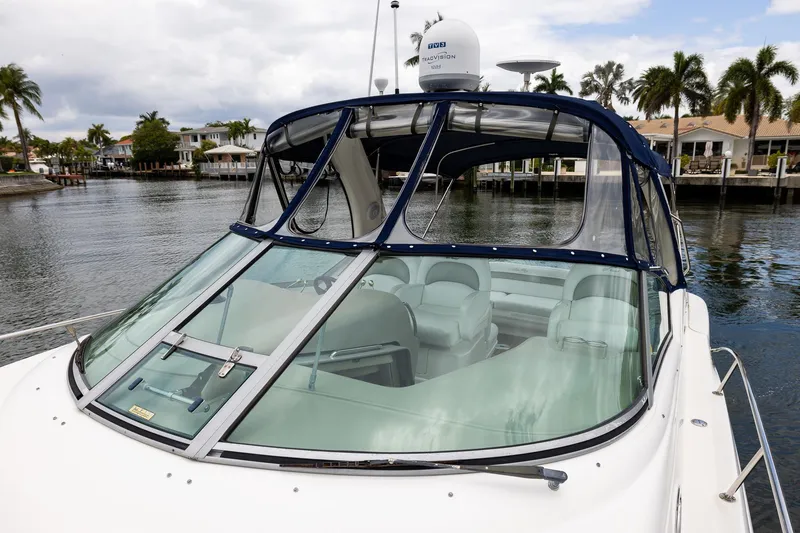 Slide: The Image of 2007 Sea Ray 340 Sundancer yacht docked by waterfront homes, featuring sleek design and spacious interior. - 15