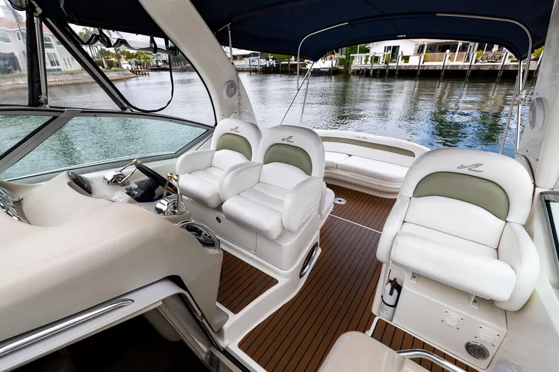 Slide: The Image of Interior of 2007 Sea Ray 340 Sundancer yacht with white seating and wooden flooring. - 16