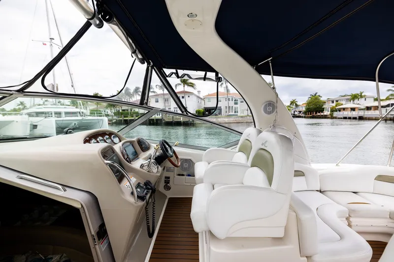 Slide: The Image of 2007 Sea Ray 340 Sundancer cockpit with luxurious seating and waterfront view. - 18