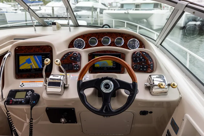 Slide: The Image of Cockpit of 2007 Sea Ray 340 Sundancer with navigation screens and controls. - 21